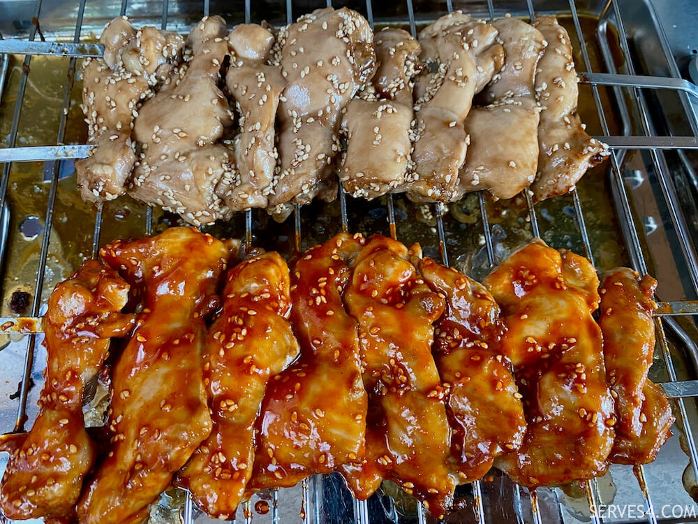 making grilled Korean chicken, spicy and non-spicy